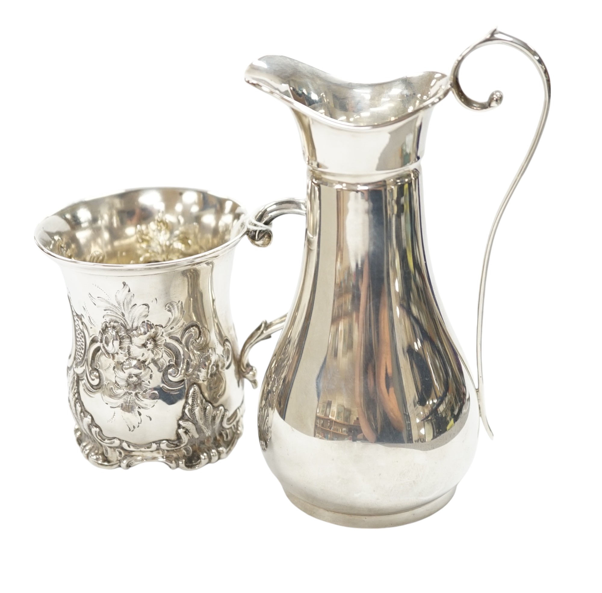 A Victorian embossed silver christening mug, George John Richards, London, 1852, 91mm, together with a later silver jug, 8.5oz. Condition - fair